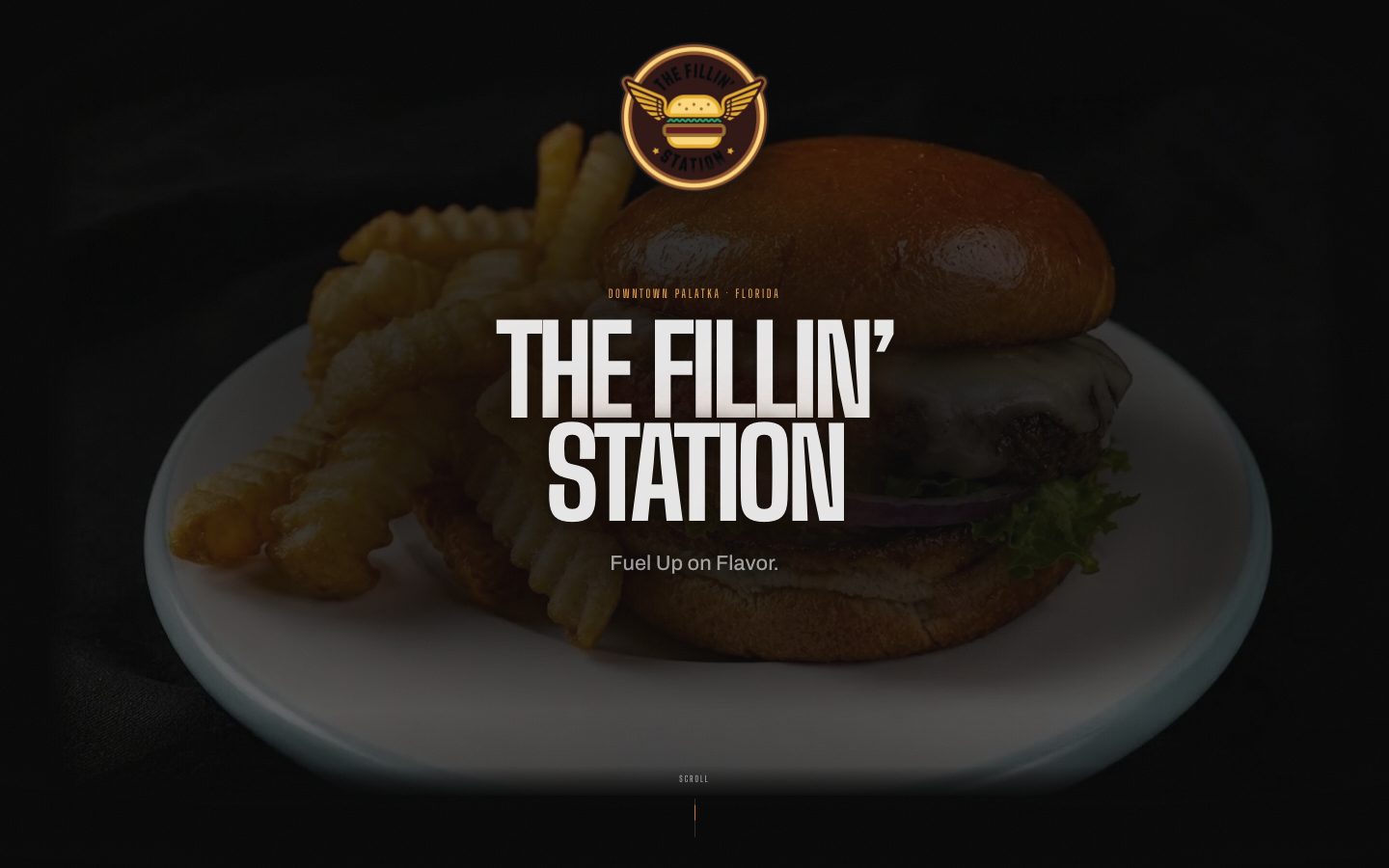The Fillin' Station homepage, a double cheeseburger and crinkle-cut fries lit against black under the words The Fillin' Station